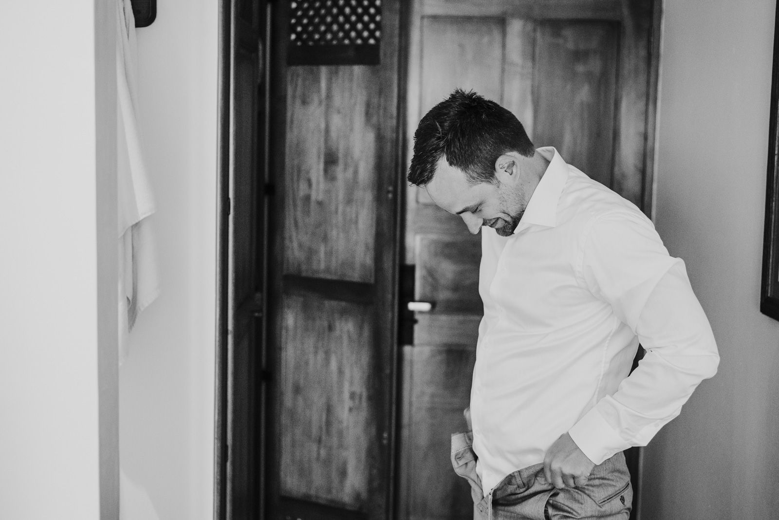 novio abrochándose los pantalones
